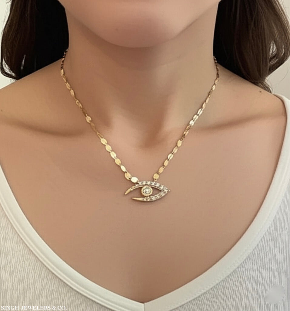 Model wearing 10k gold evil eye necklace with diamond accents – good luck jewelry