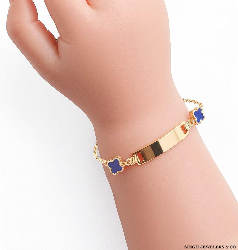 Wrist view of 10k yellow gold baby blue clover ID bracelet