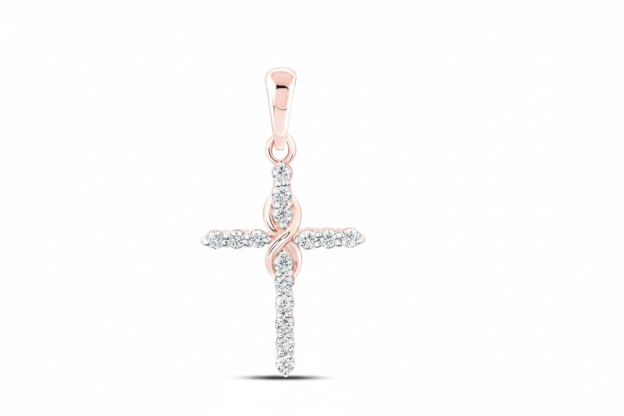 Rose gold and silver cross pendant on a white background