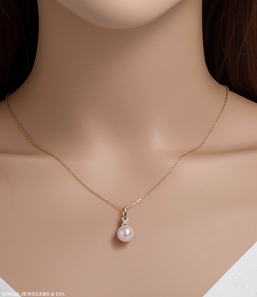 Model wearing 10k yellow gold infinity necklace with pearl and diamond accents