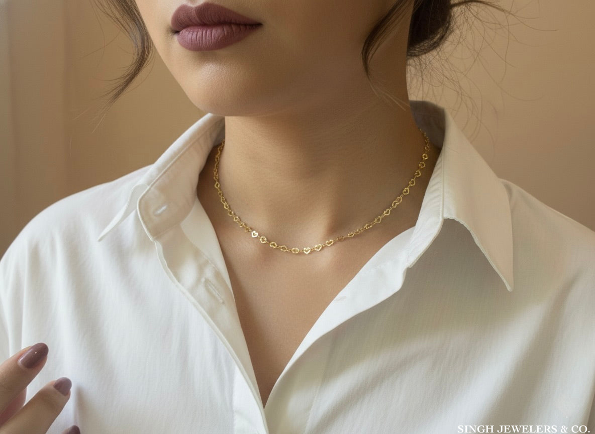 Intertwined hearts gold necklace worn on model