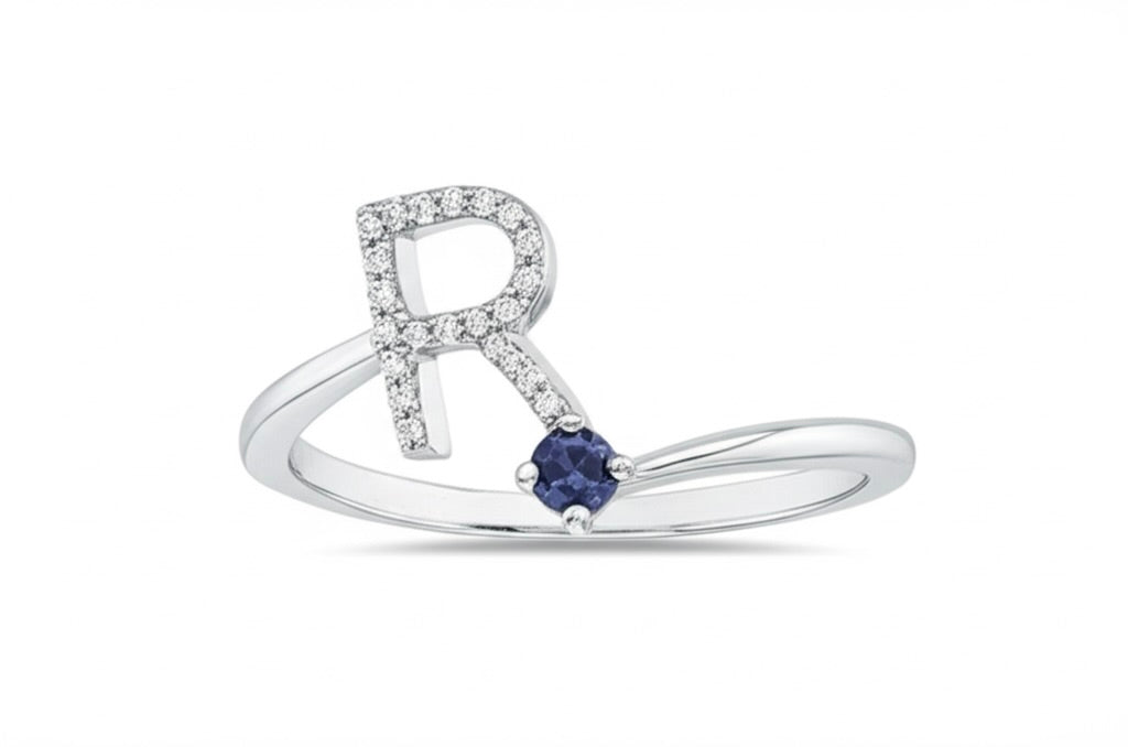 white gold ring with a blue sapphire on a white background