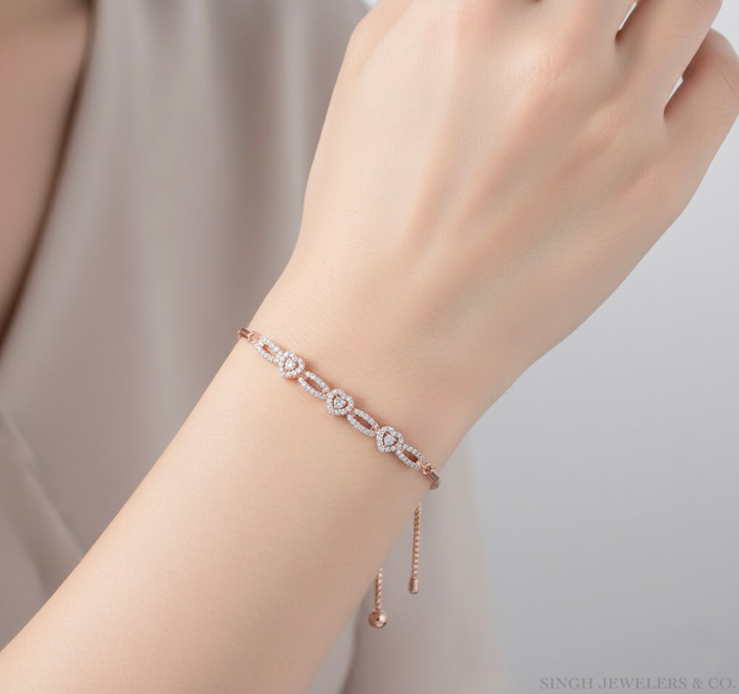 Hand wearing a delicate bracelet on a neutral background