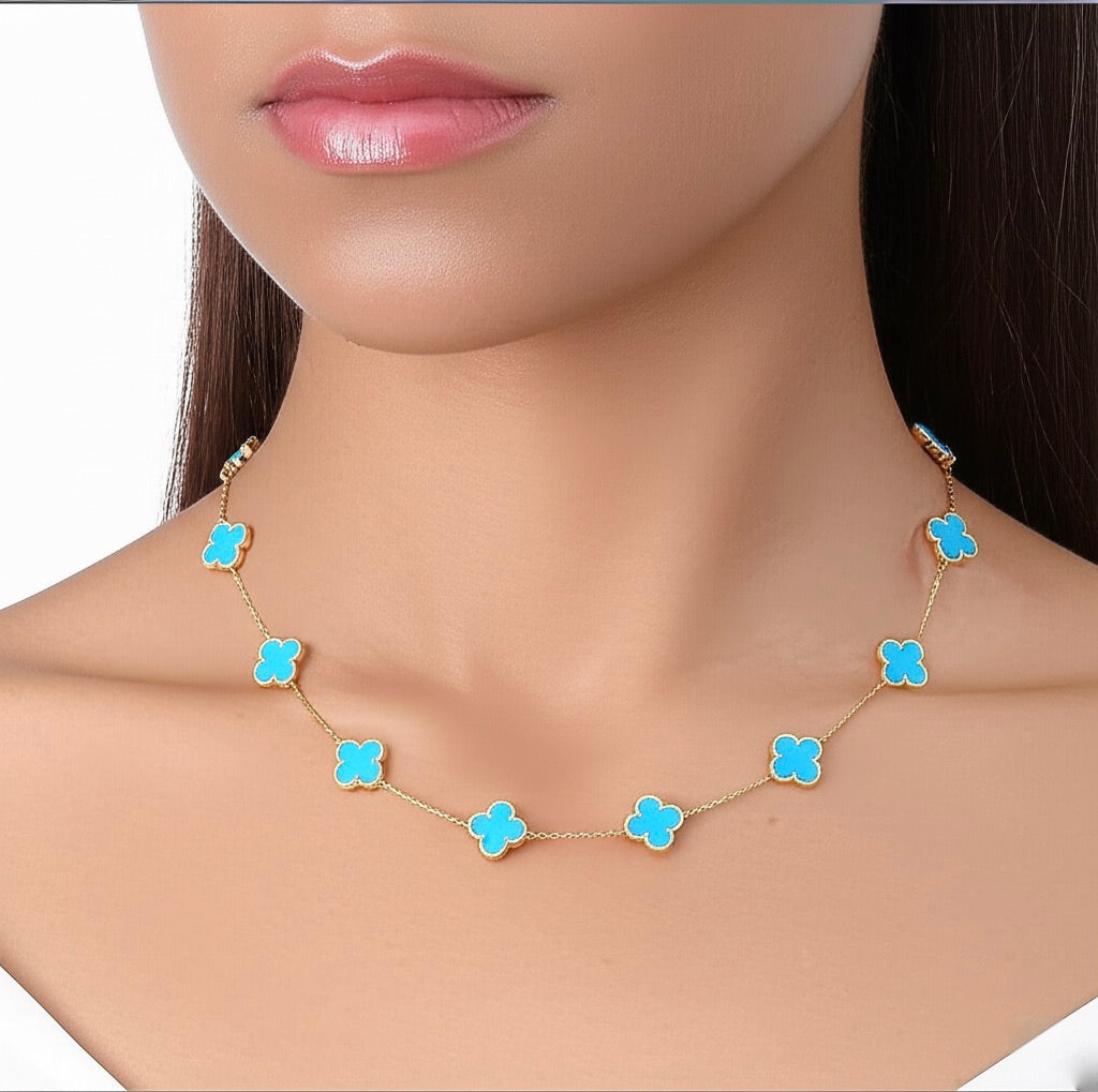 Woman wearing 10K gold necklace with sky blue clover pendant