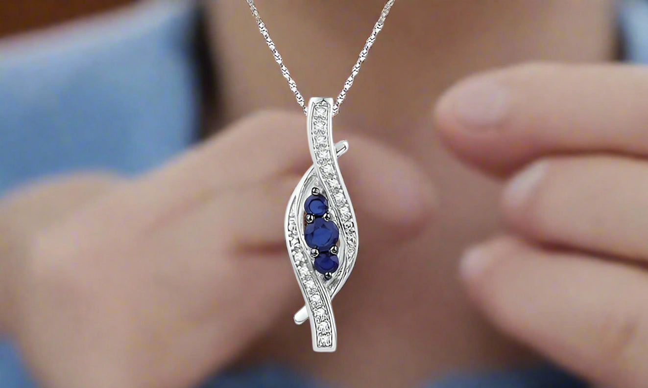 10K White Gold Blue Sapphire and Diamond Pendant on 20" Twisted Chain.
