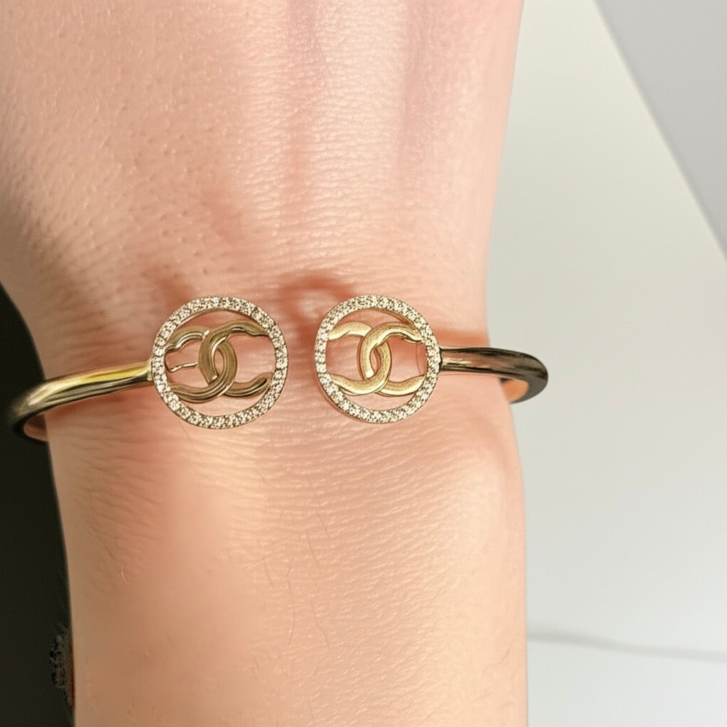 10K yellow gold Chanel white sapphire bangle worn on wrist