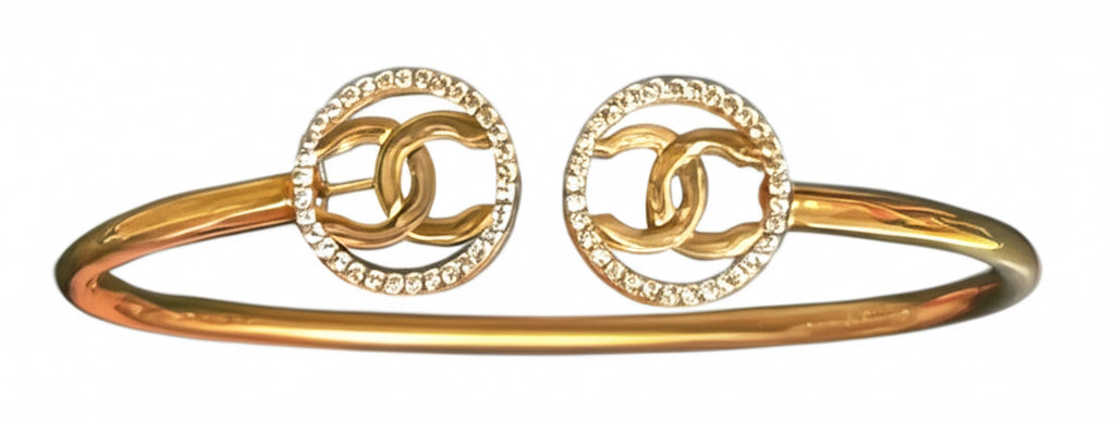 Elegant 10K yellow gold bangle featuring white sapphires in Chanel design