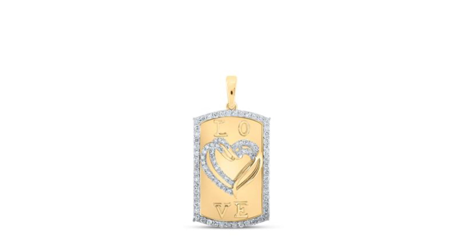Close-up of a 10K yellow gold dog tag heart pendant from Nicole’s Dream Collection, adorned with 5/8 CTTW sparkling round diamonds.