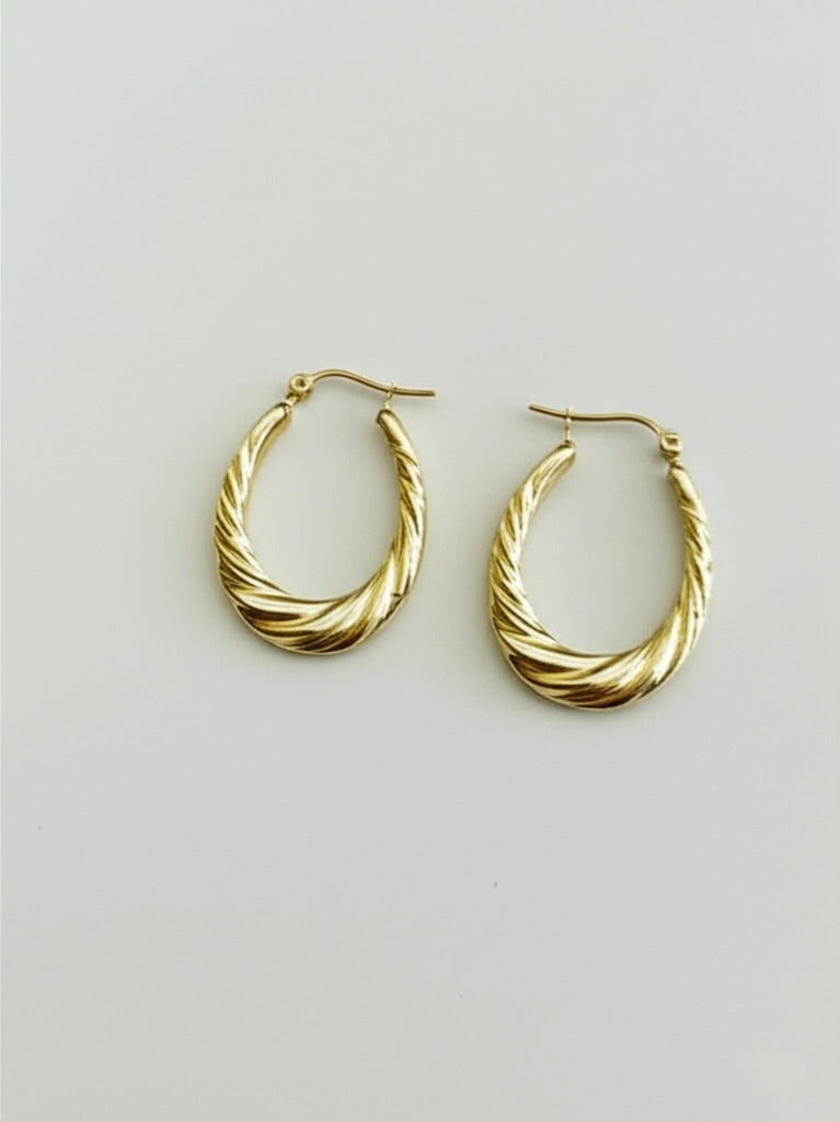 10K Yellow Gold Twisted Oval Hoop Earrings on white background