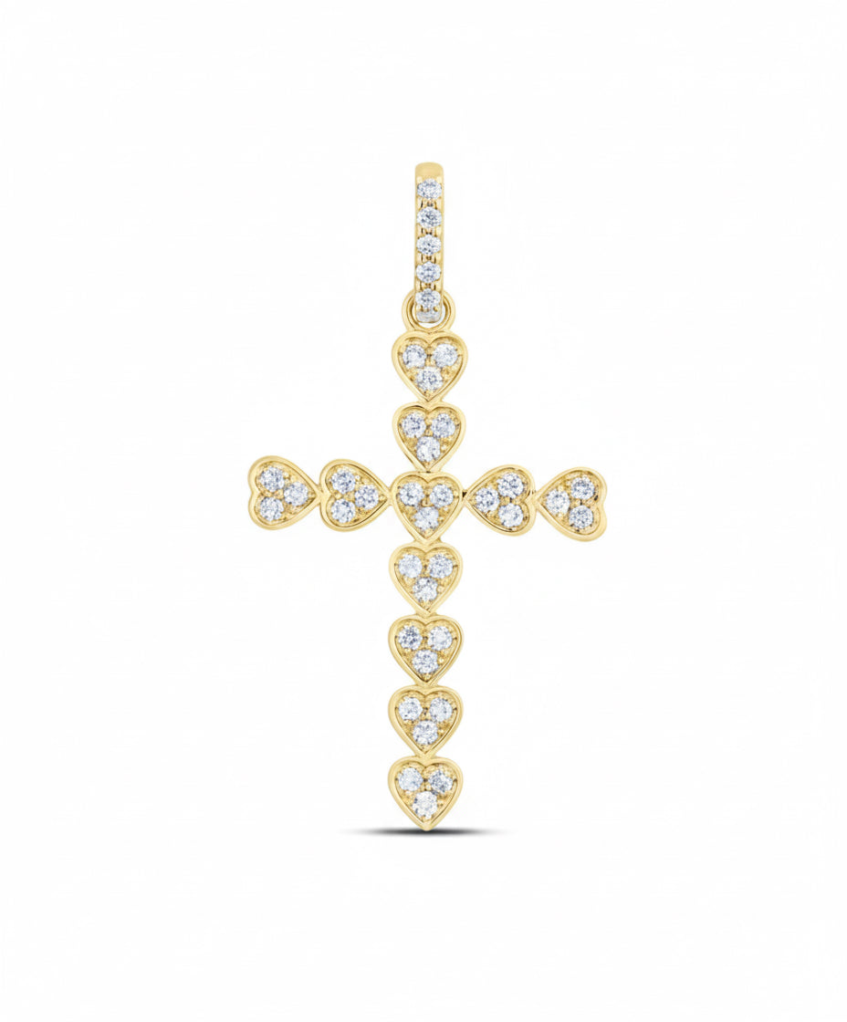 Gold cross pendant with heart-shaped diamond accents on a white background