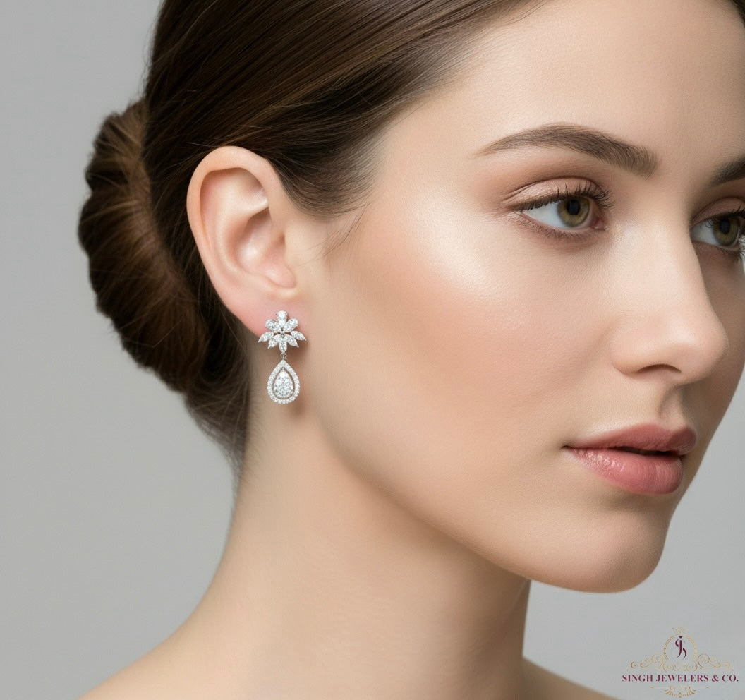 Close-up of a woman wearing diamond earrings with a neutral background