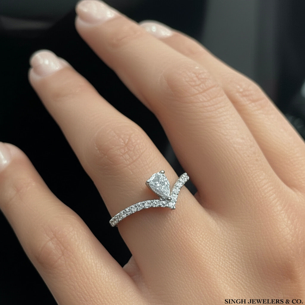 14k yellow gold pear-shaped diamond ring featuring 5/8 Cttw of brilliant diamonds, modeled on a hand.