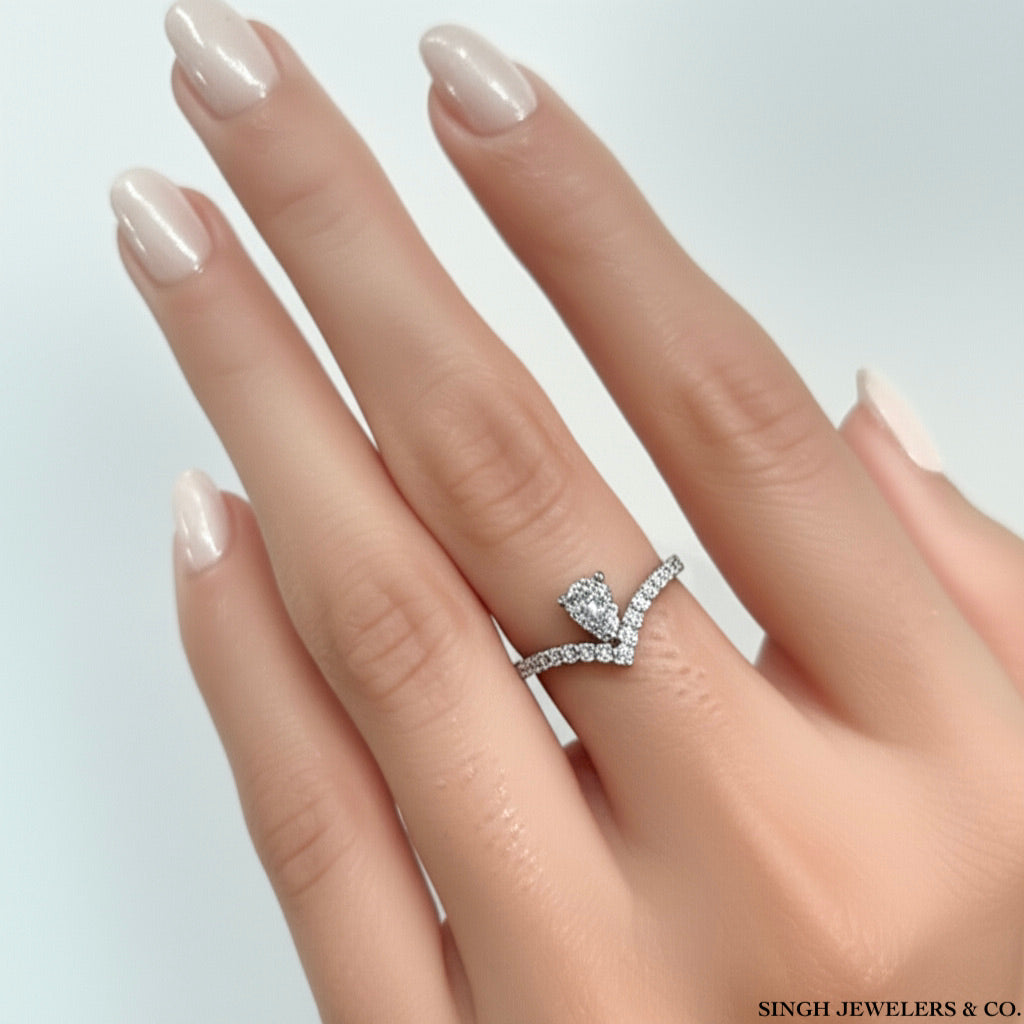 14k yellow gold pear-shaped diamond ring featuring 5/8 Cttw of brilliant diamonds, modeled on a hand.