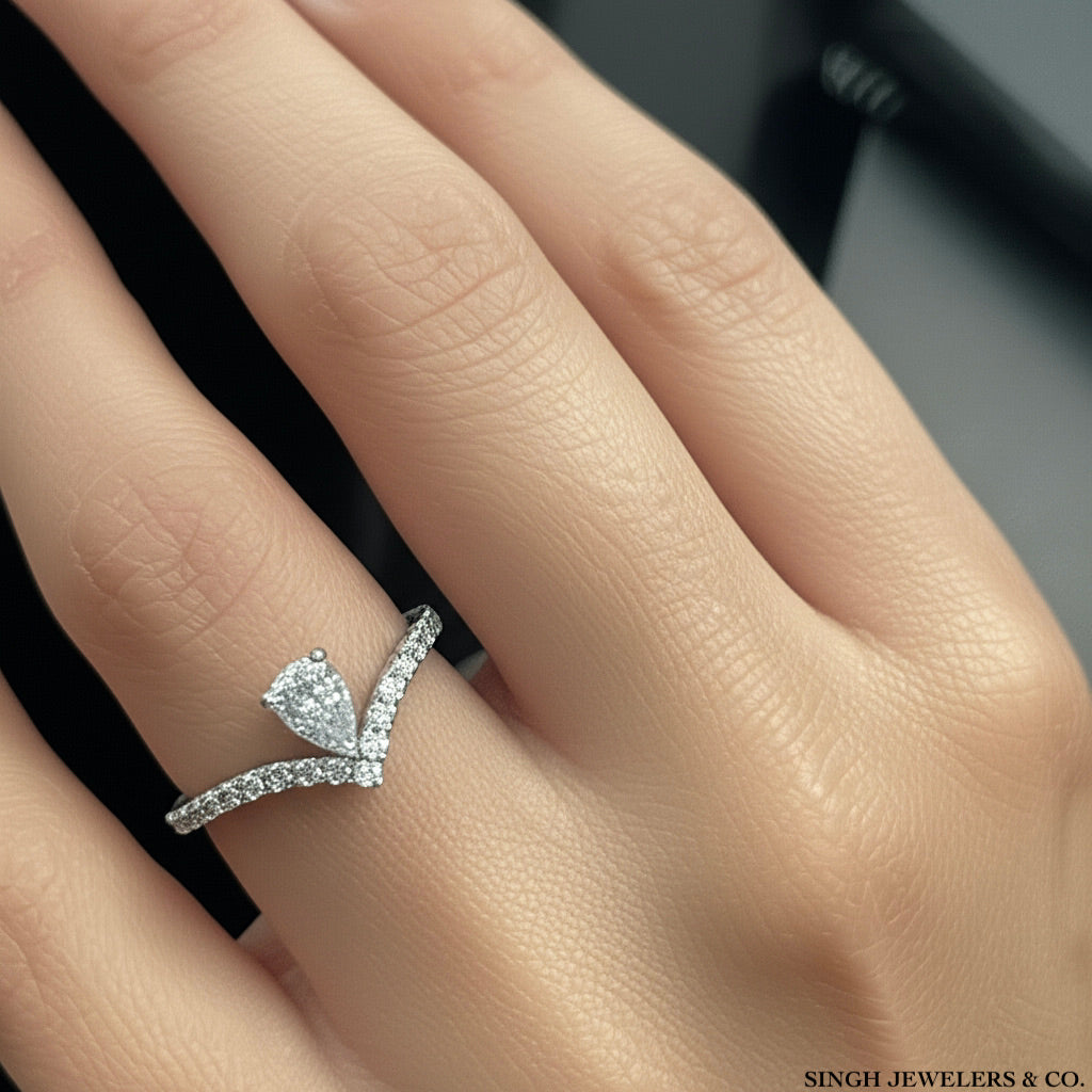 14k yellow gold pear-shaped diamond ring featuring 5/8 Cttw of brilliant diamonds, modeled on a hand.