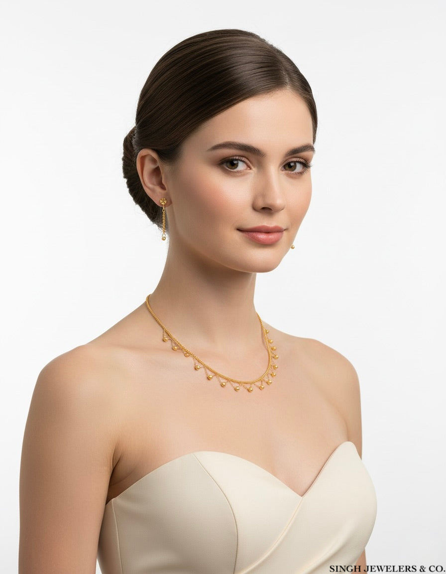 Woman wearing a gold necklace with a plain background