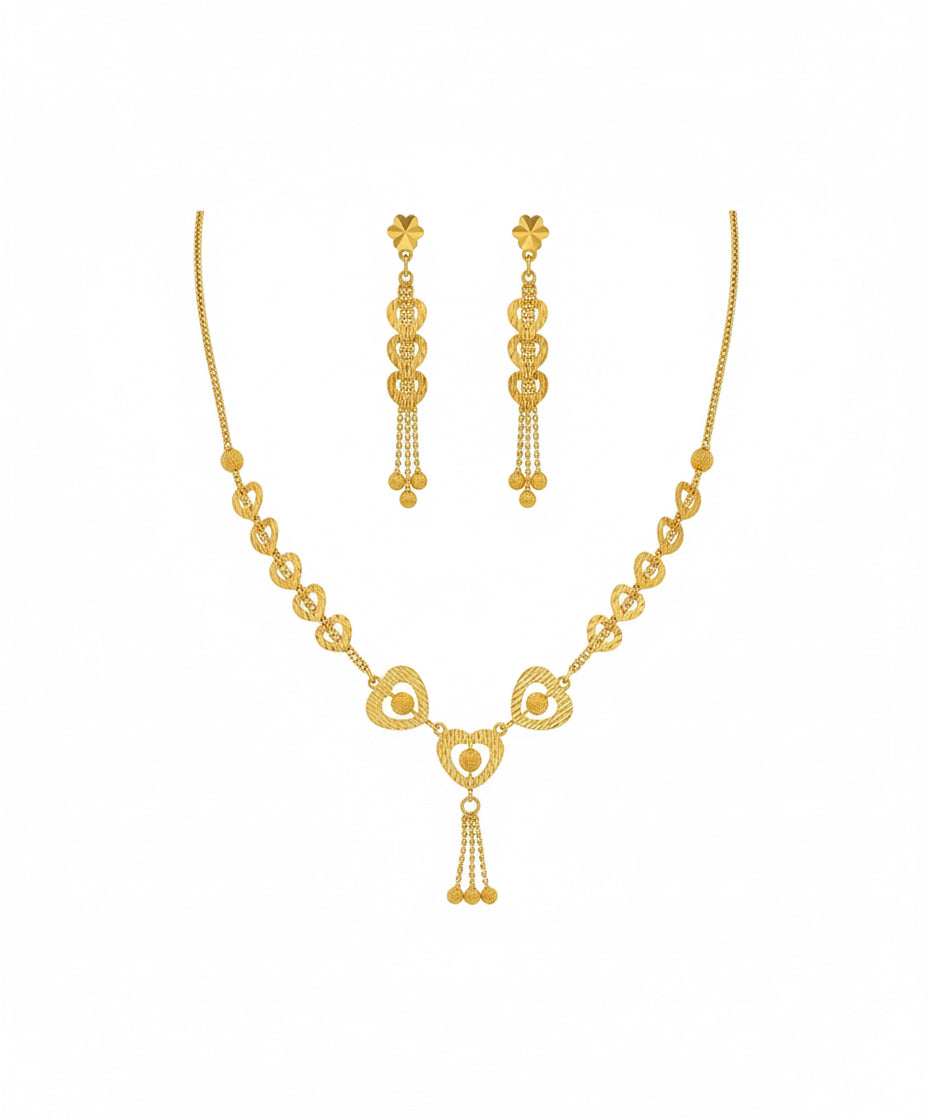 Gold necklace and earrings set on a white background