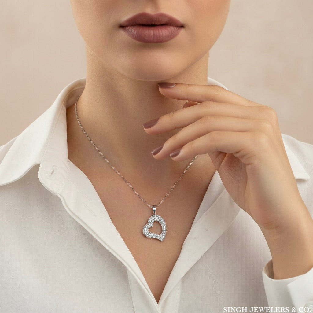 Model wearing a 925 sterling silver cubic zirconia open heart charm pendant