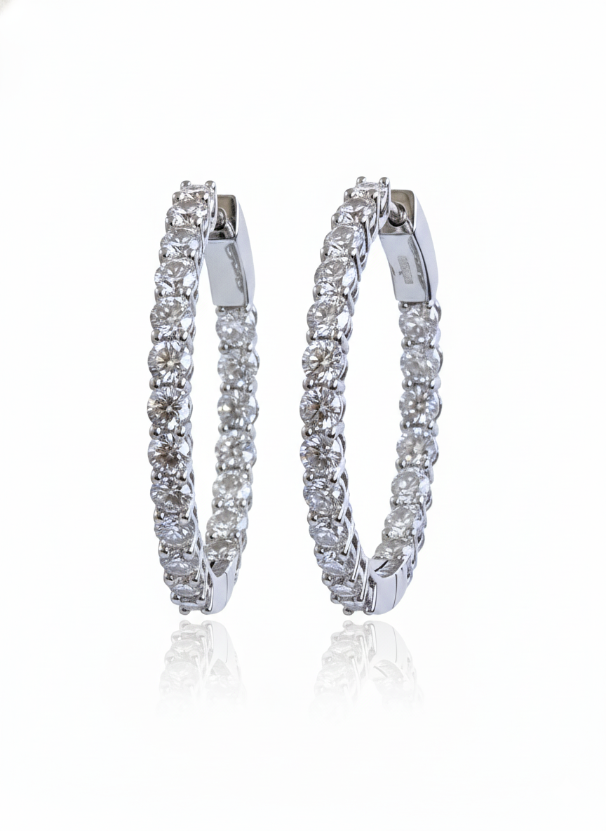 Pair of diamond hoop earrings on a white background