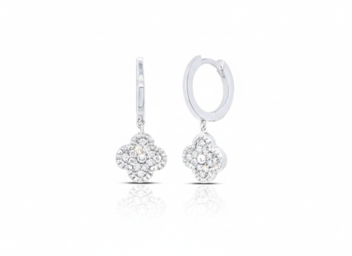 Pair of silver earrings with clear stones on a white background