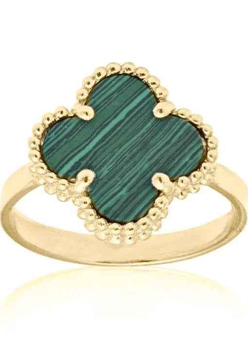 A 10K yellow gold ring with a green clover-shaped stone in a split shank setting, adorned with small beads along the shank.