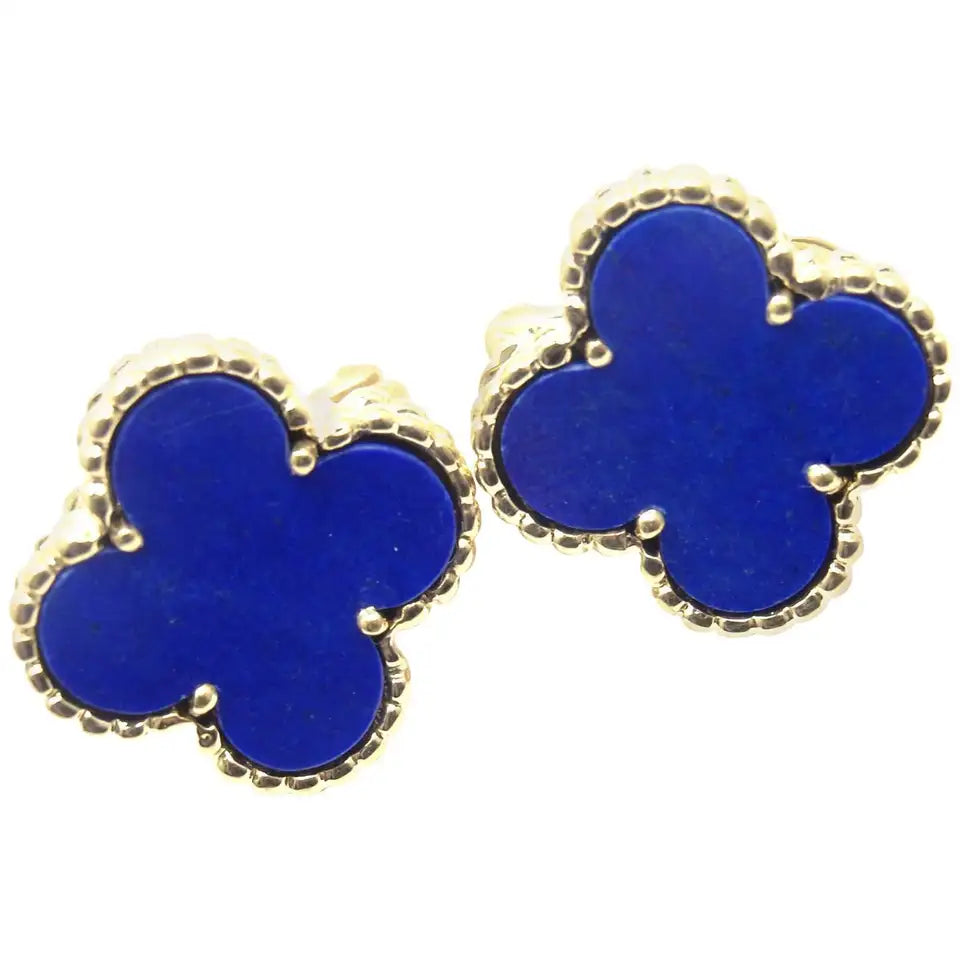 Close-up of four-leaf clover earrings in gold and royal blue enamel