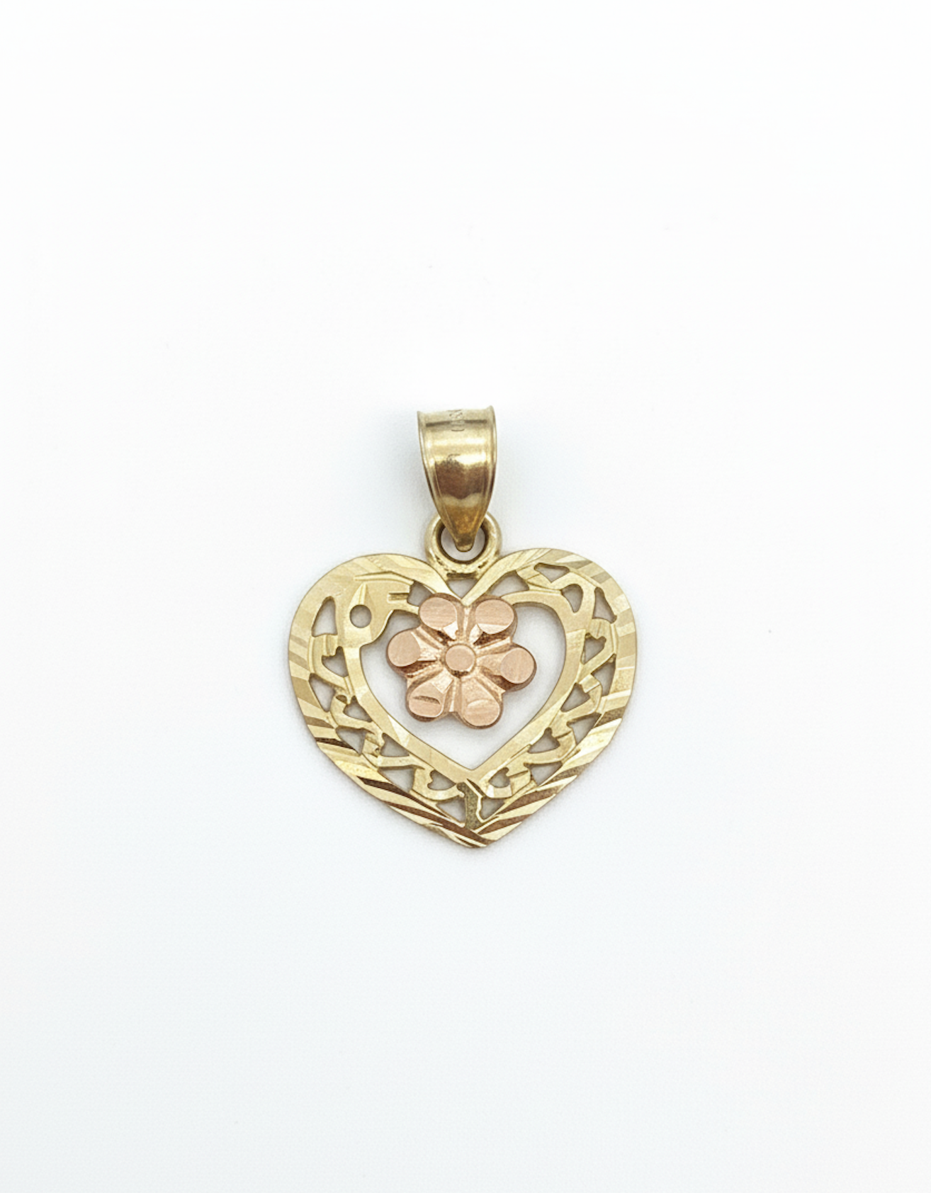 Gold heart-shaped pendant with floral design on a white background