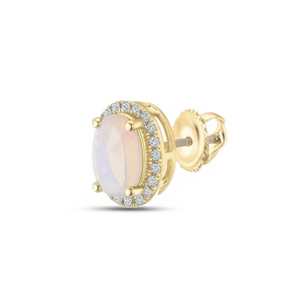 Gold earring with a central gemstone and diamond accents on a white background