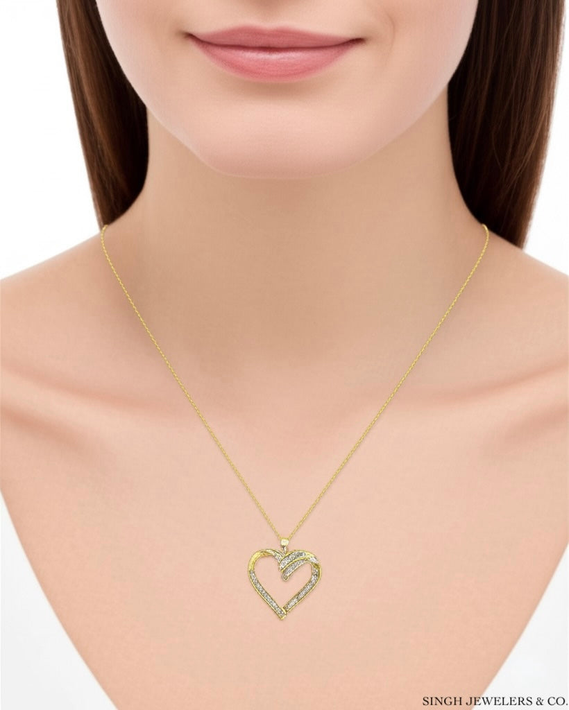 10K gold heart-shaped charm with baguette-cut diamonds and 18-inch chain