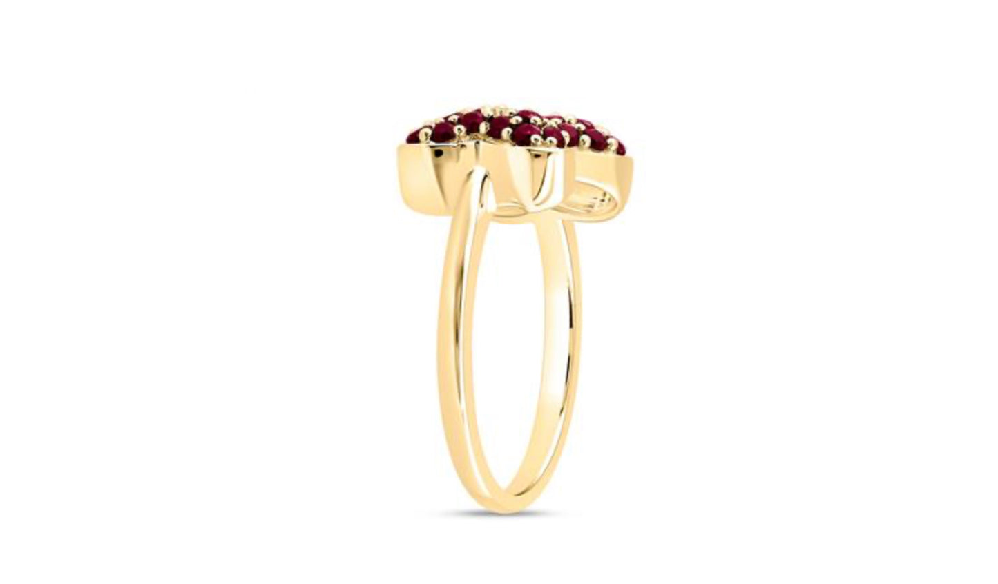 Gold ring with red gemstones on a white background