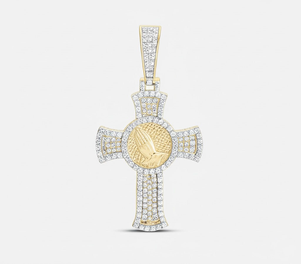 Gold cross pendant with a central round emblem on a light gray background
