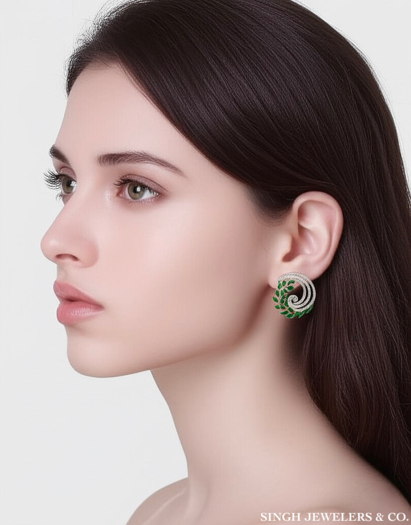 Woman wearing a green and silver earring with Singh Jewelers & Co. branding.