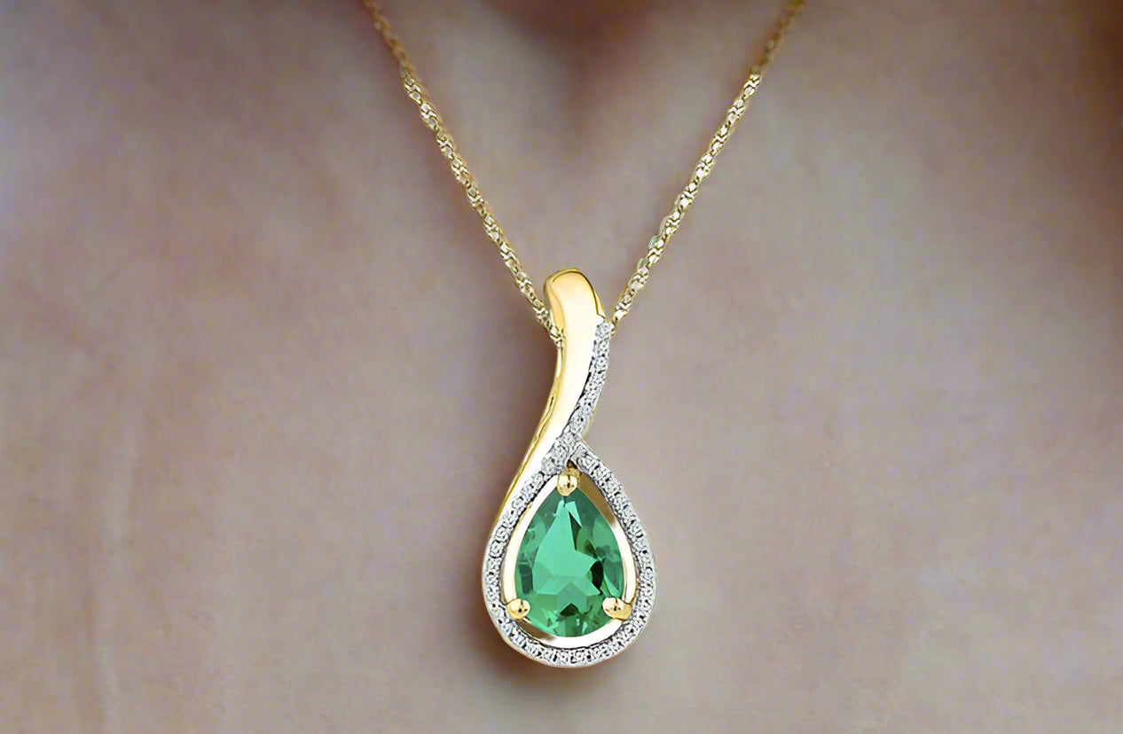 10k yellow gold pear-shaped synthetic emerald pendant with 1/12 Cttw diamond accents