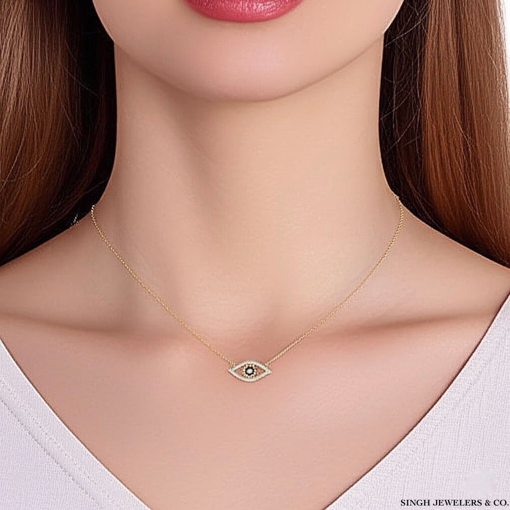 Gold necklace with an eye pendant on a mannequin neck, branded 'Singh Jewelers & Co'.