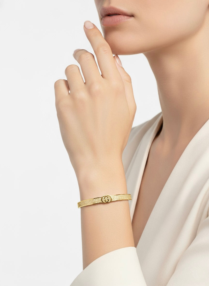 Woman wearing Gucci-inspired gold tone stainless steel bangle