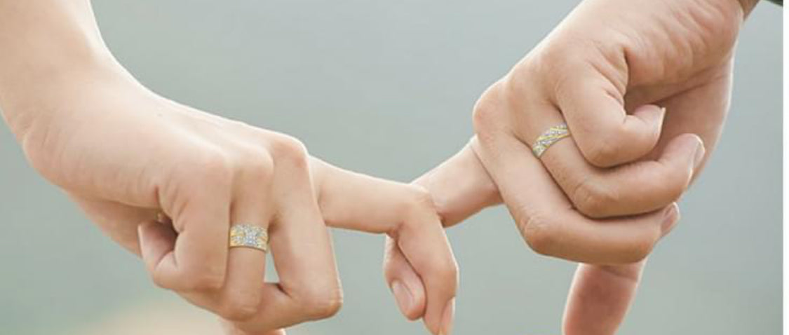 Couple wearing matching 10K yellow gold diamond ring set