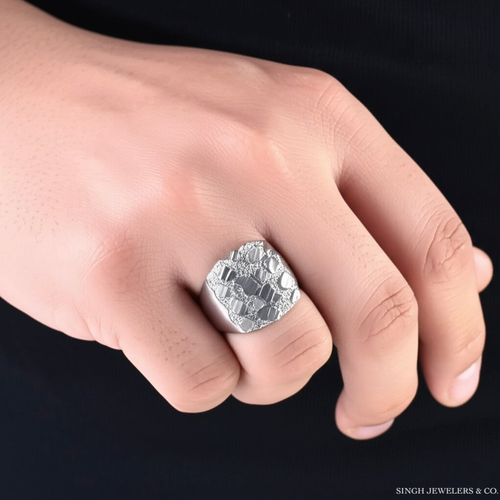 Male model wearing sterling silver diamond-cut nugget ring on right hand