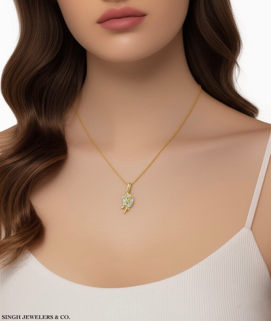 Model wearing 10K yellow gold rose charm necklace, 18-inch chain