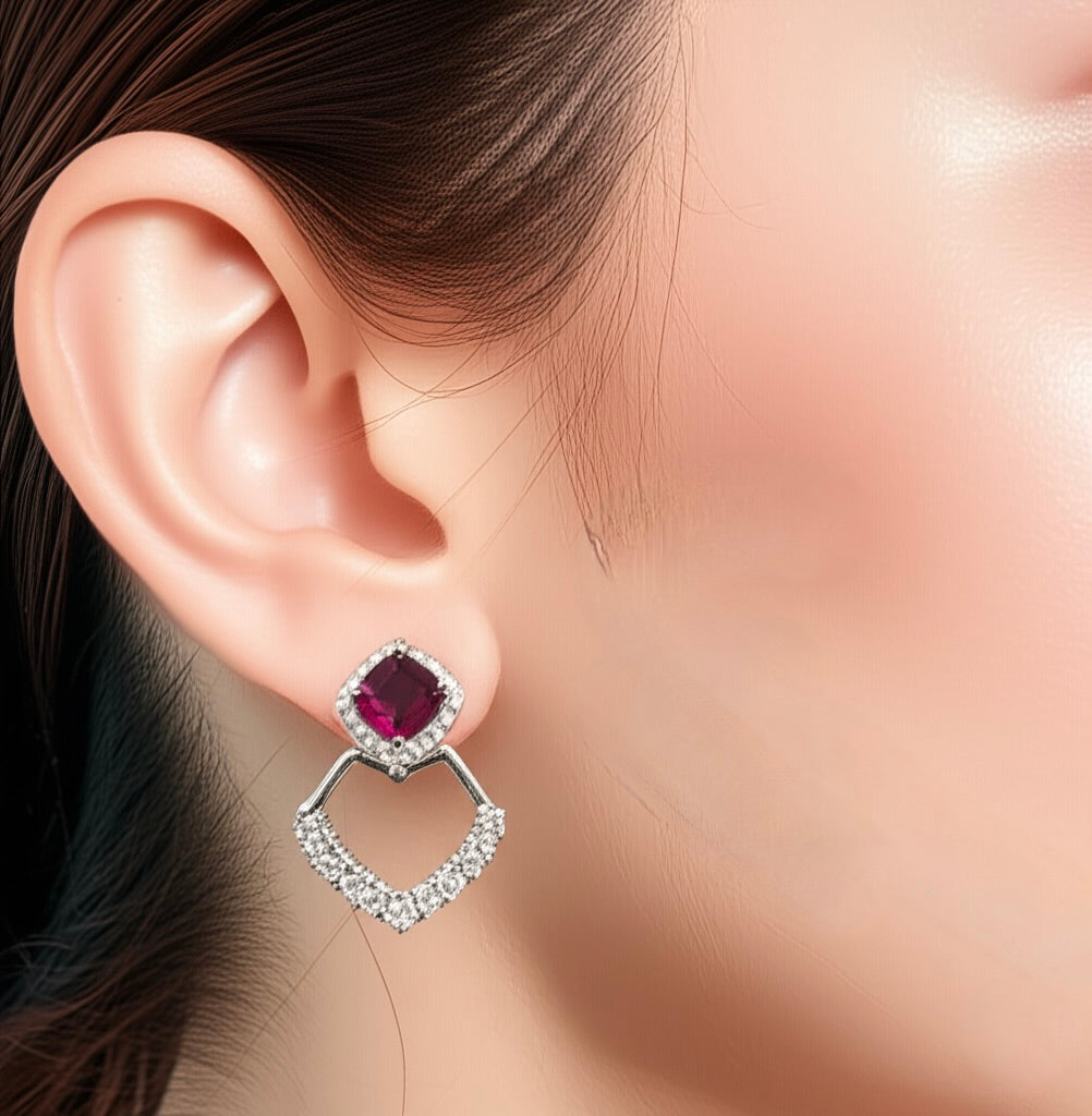 Model wearing sterling silver dangle earrings with cushion-cut synthetic ruby and cubic zirconia