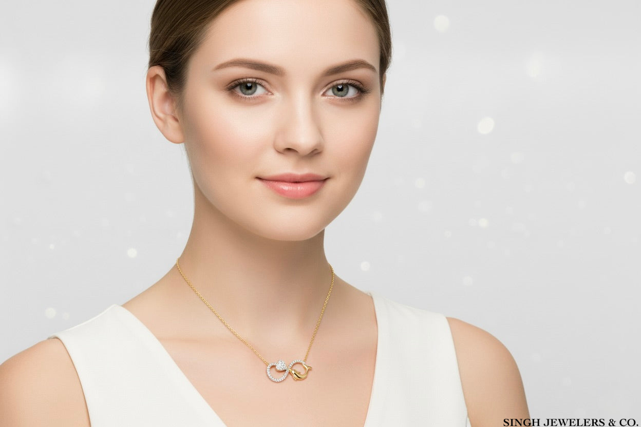 Woman wearing a gold necklace on a light background with 'Singh Jewelers & Co.' branding.