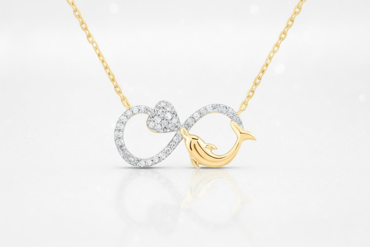 Gold and silver necklace with a dolphin design on a white background