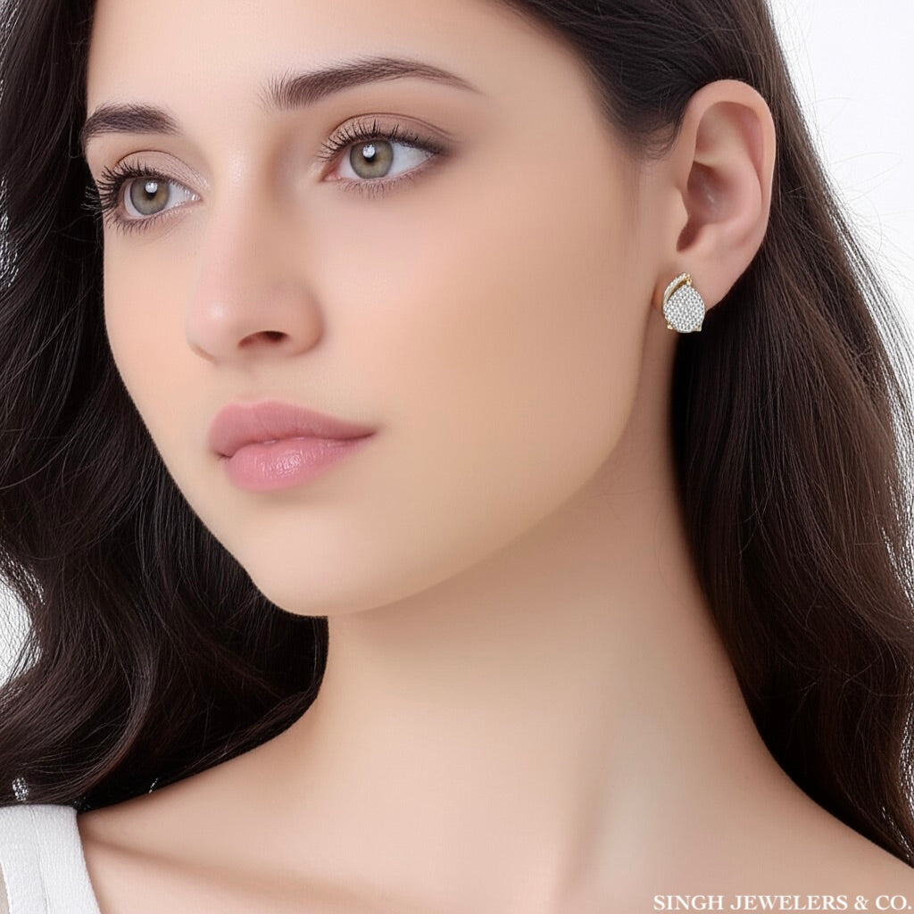 Close-up of a woman wearing diamond earrings with 'Singh Jewelers & Co.' branding.