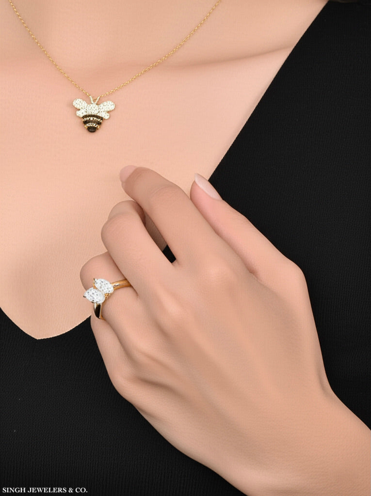 Woman’s hand wearing 1/4CT pear oval diamond ring in 14K yellow gold