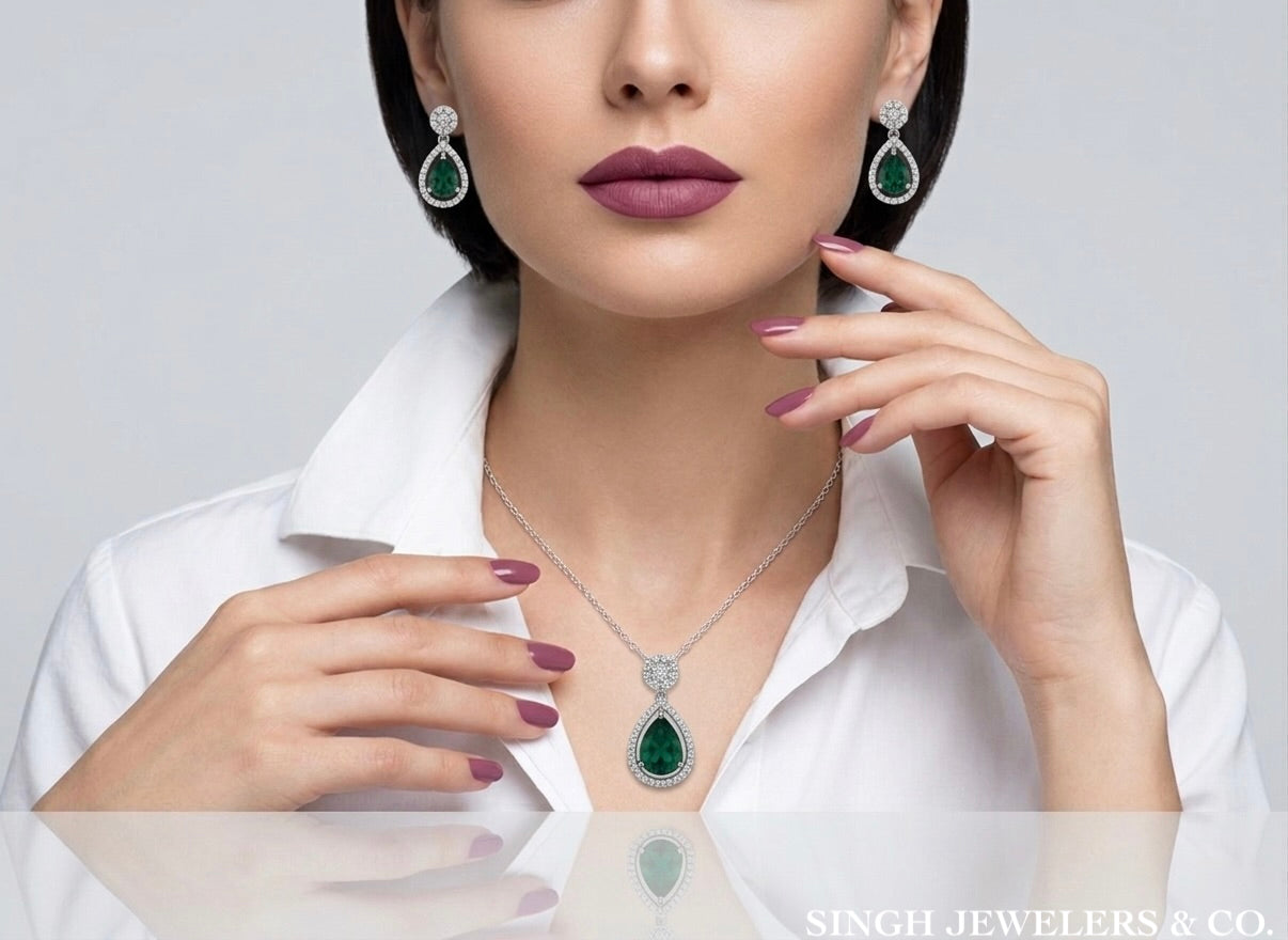 Close-up of pear-shaped green CZ necklace worn on model in sterling silver setting
