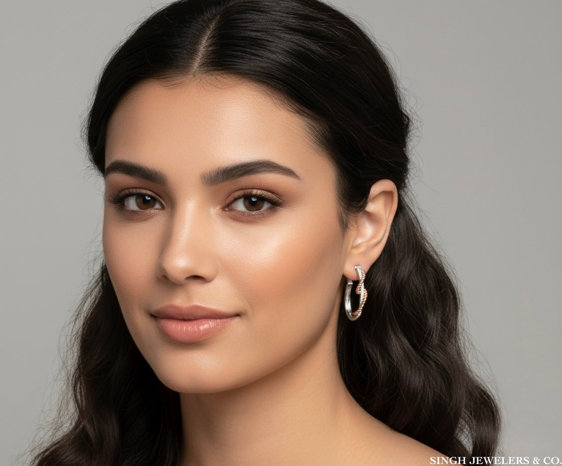 Woman wearing silver hoop earrings against a gray background