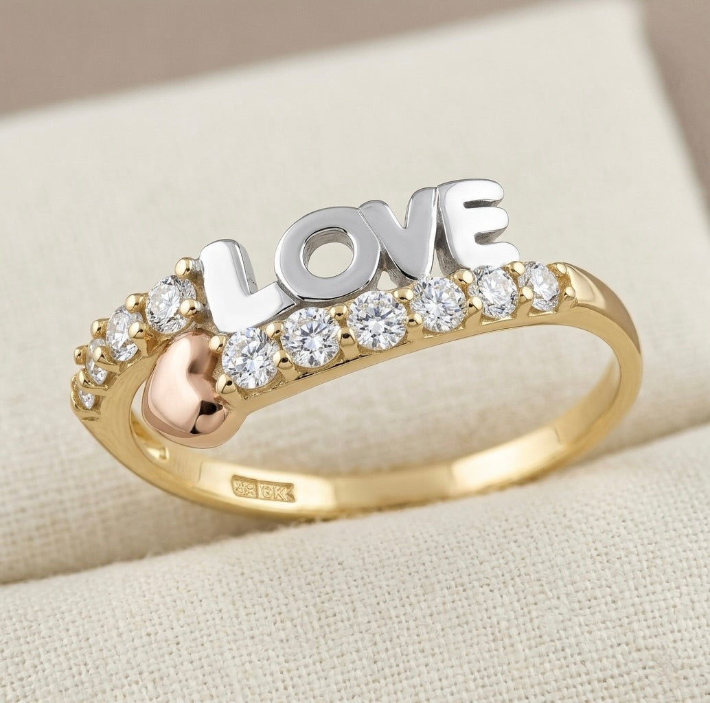 rose gold heart detail on 10K tri-tone gold ring with white sapphires