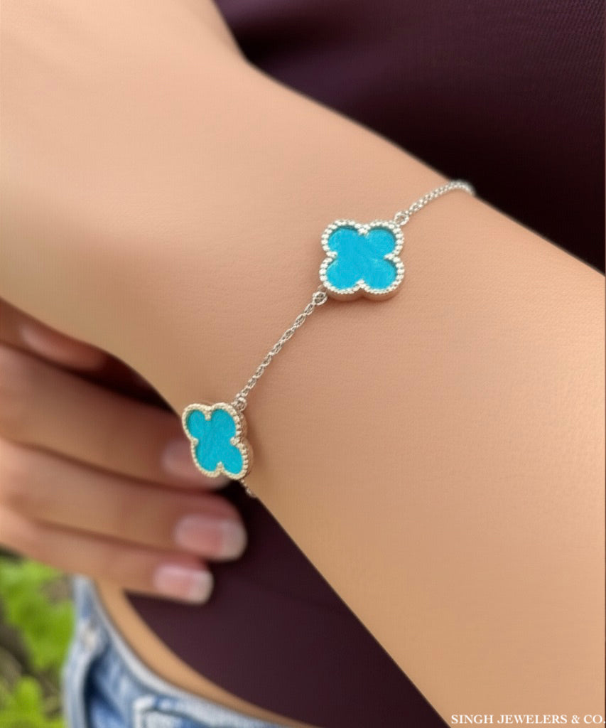 Stainless steel bracelet with sky blue clover design" or "Elegant stainless steel clover bracelet with sky blue color.