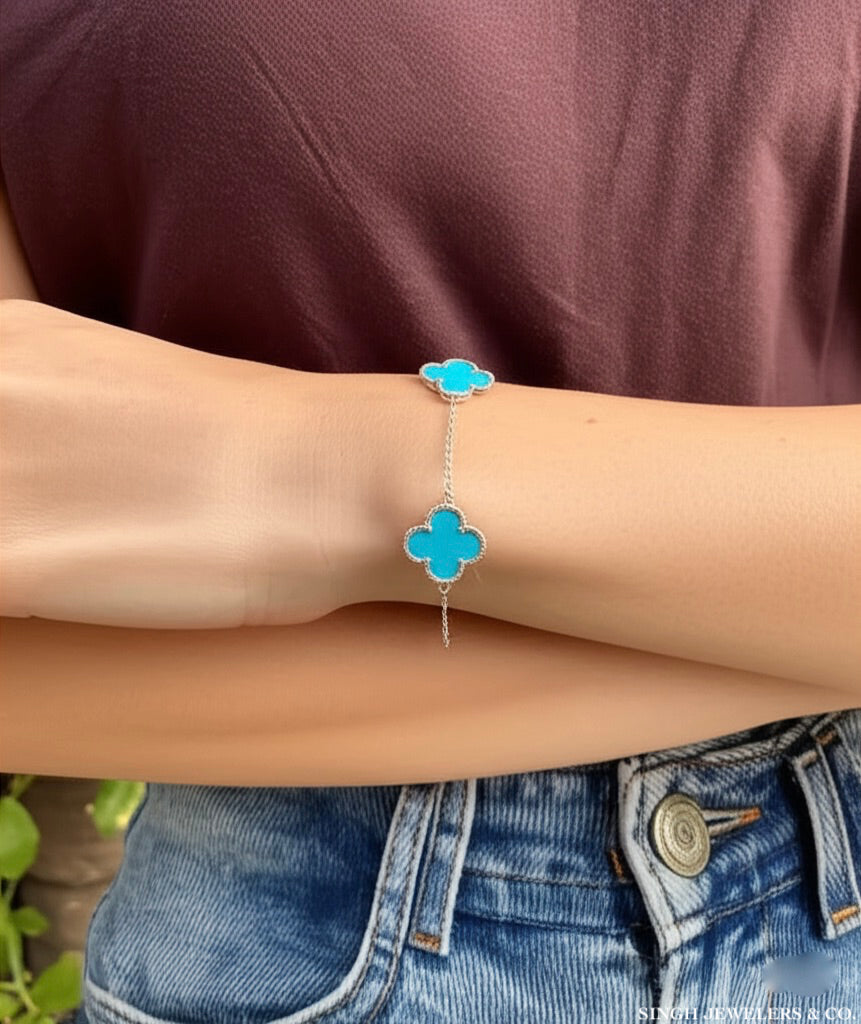 Stainless steel bracelet with sky blue clover design" or "Elegant stainless steel clover bracelet with sky blue color.