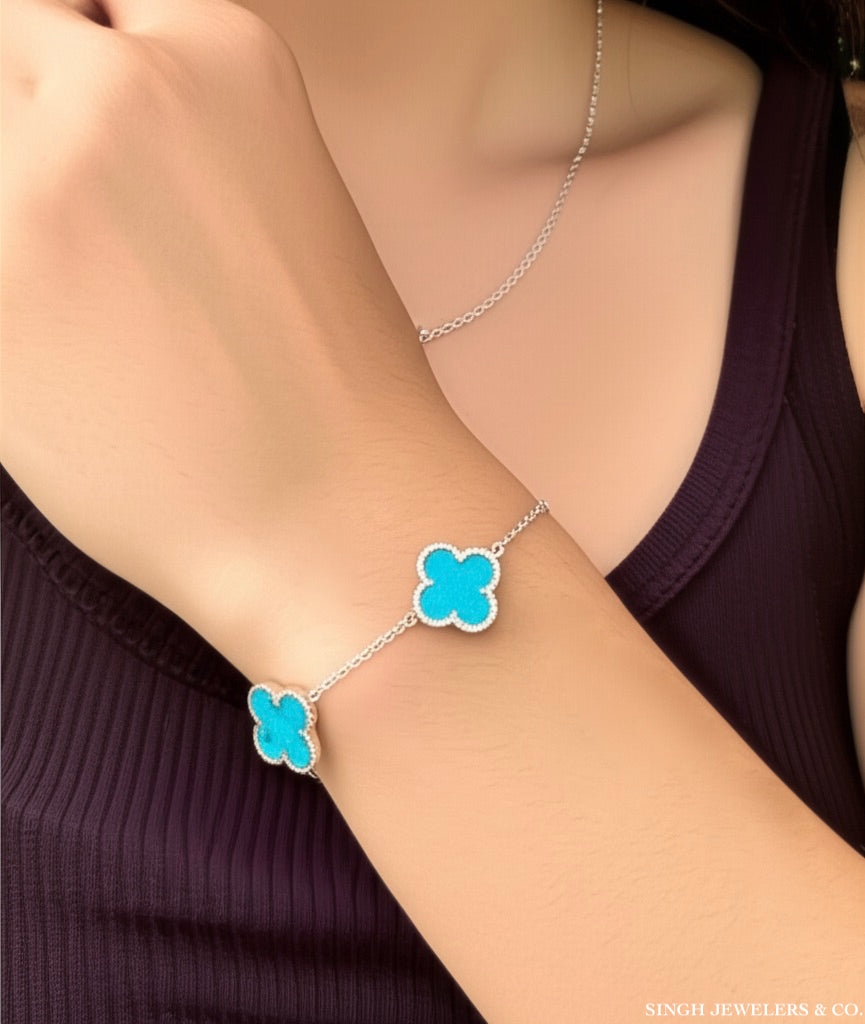 Stainless steel bracelet with sky blue clover design" or "Elegant stainless steel clover bracelet with sky blue color.