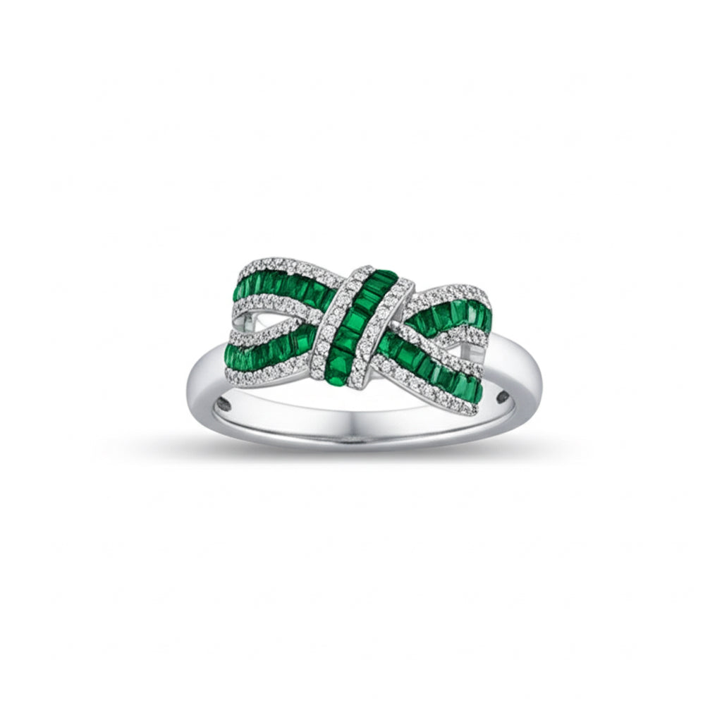 Sterling silver bow ring featuring white sapphires and green stones