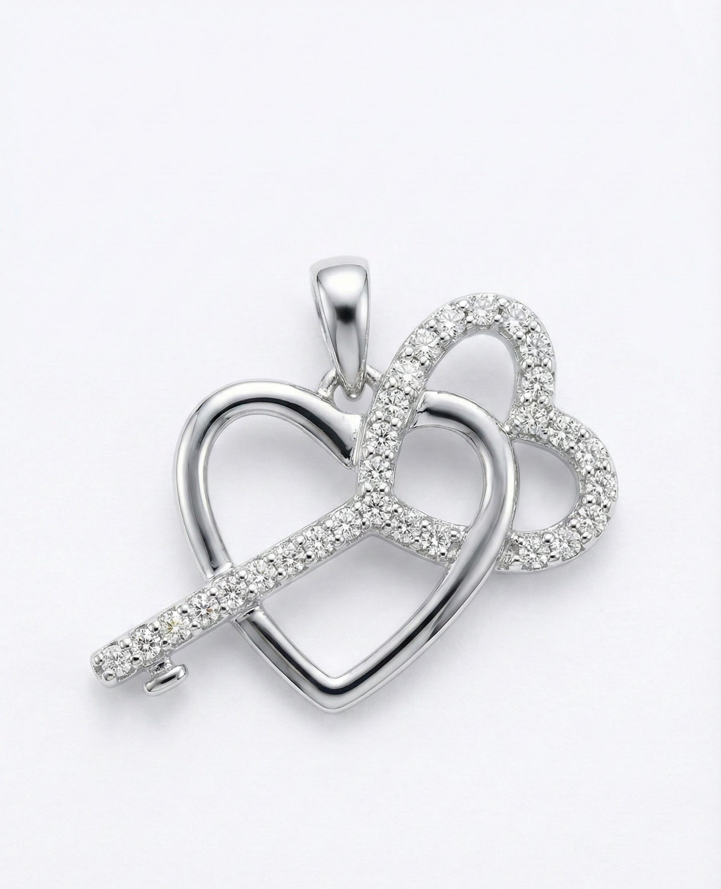Silver heart-shaped pendant with embedded stones on a white background